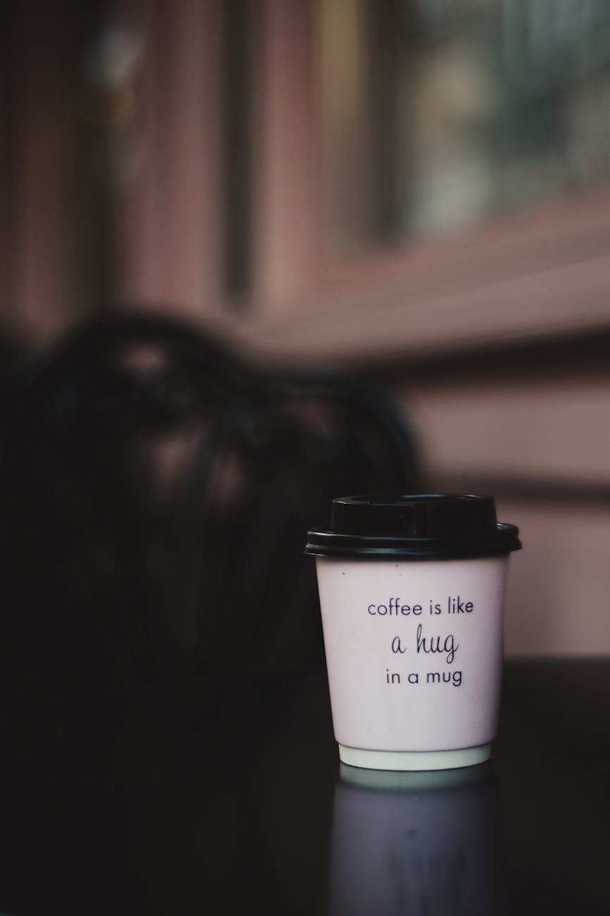 photo of coffee cup on wooden surface