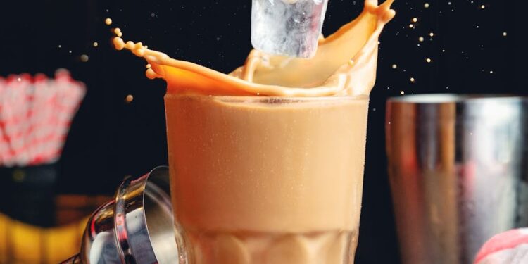 a photo of hand putting ice on a coffee